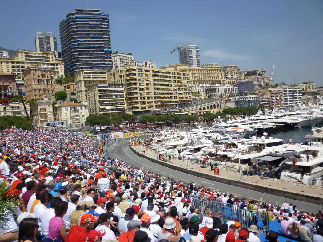 Fans cheering with Mostbet banners at Monaco